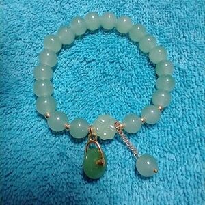 Goldtone green faux jade wheel stretch bracelet